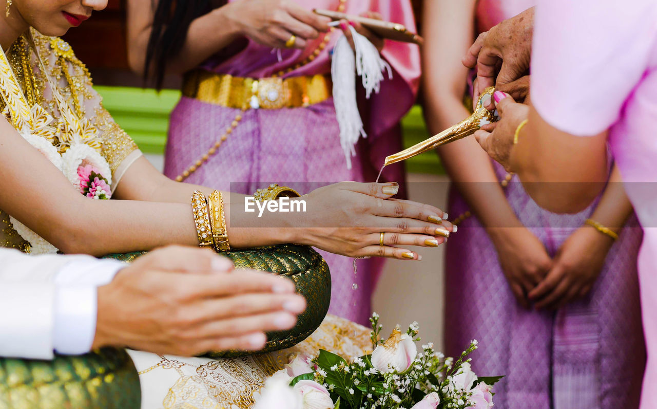 Midsection of people during wedding ceremony