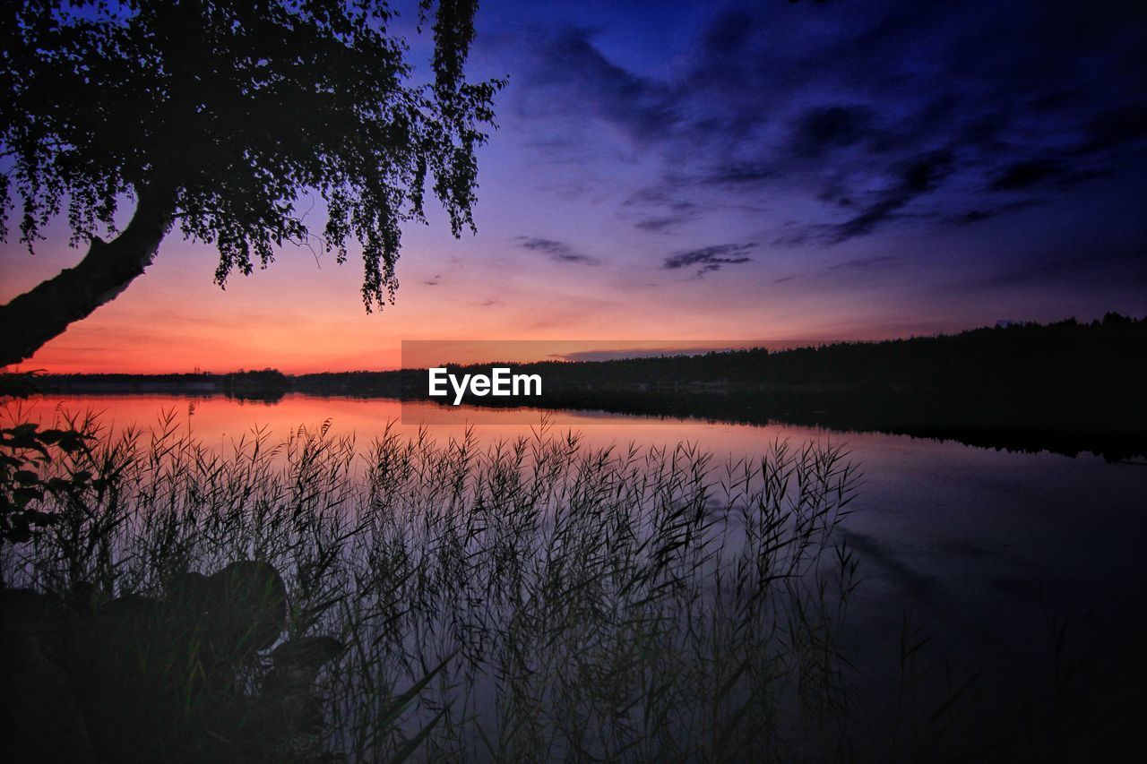 Scenic view of lake against romantic sky at sunset