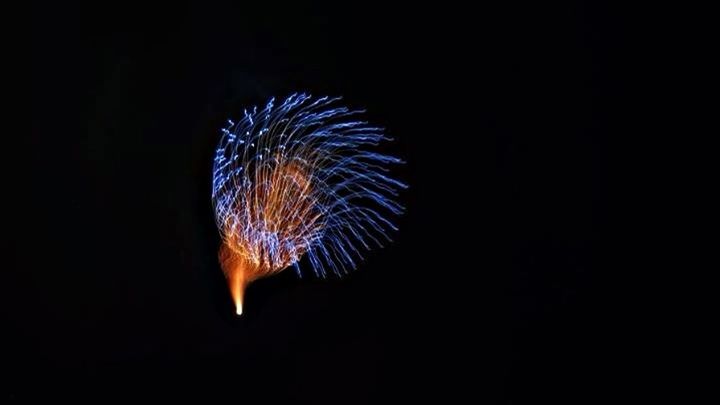 LOW ANGLE VIEW OF FIREWORKS DISPLAY