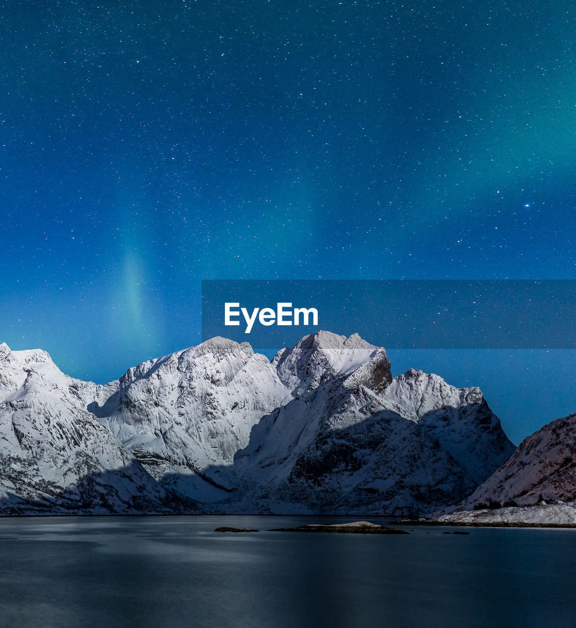 Scenic view of snowcapped mountains against sky at night