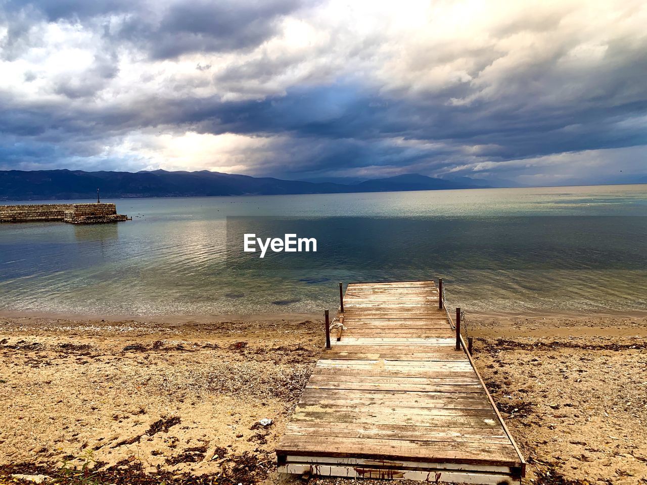 Pier over sea against sky