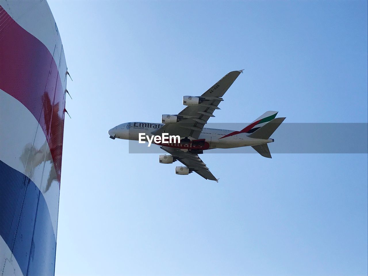 LOW ANGLE VIEW OF AIRPLANE AGAINST CLEAR SKY