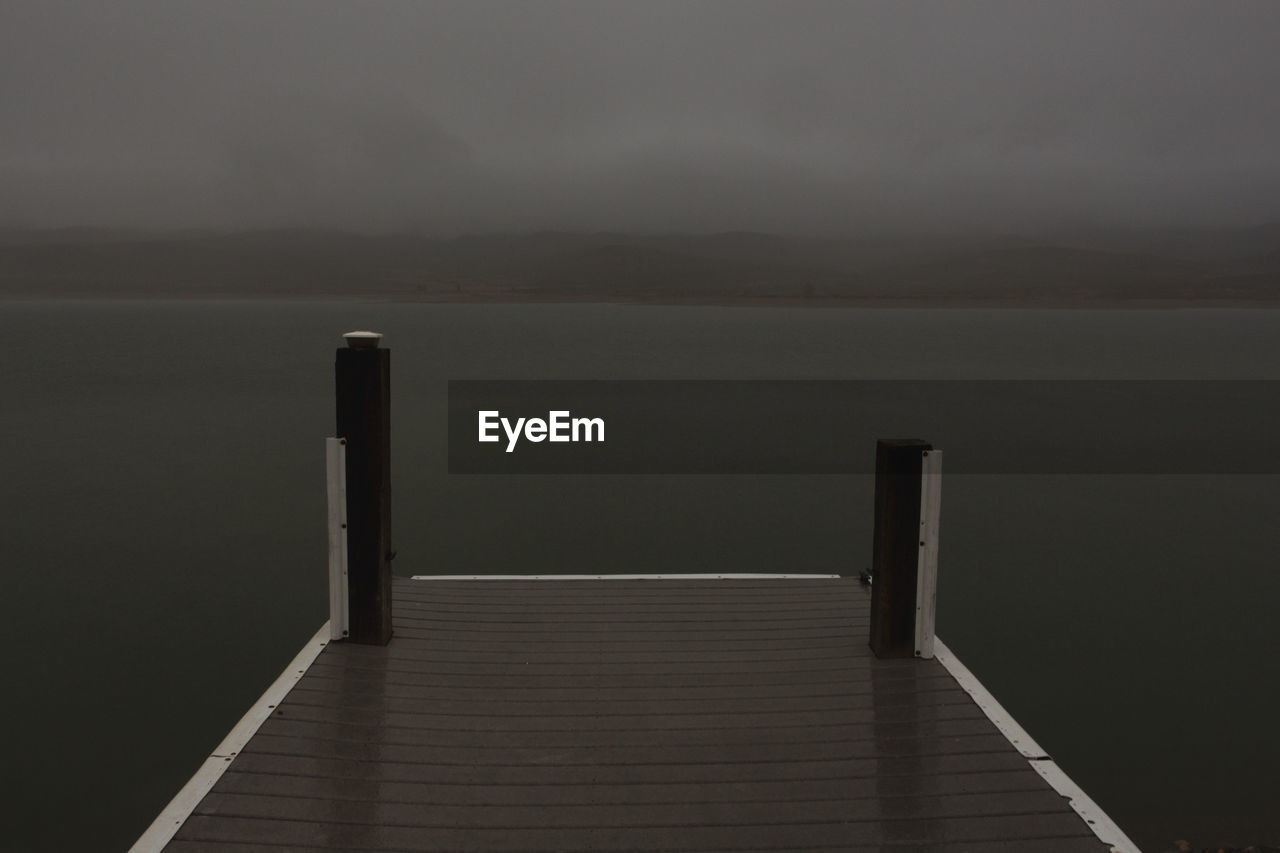 Pier over lake against sky