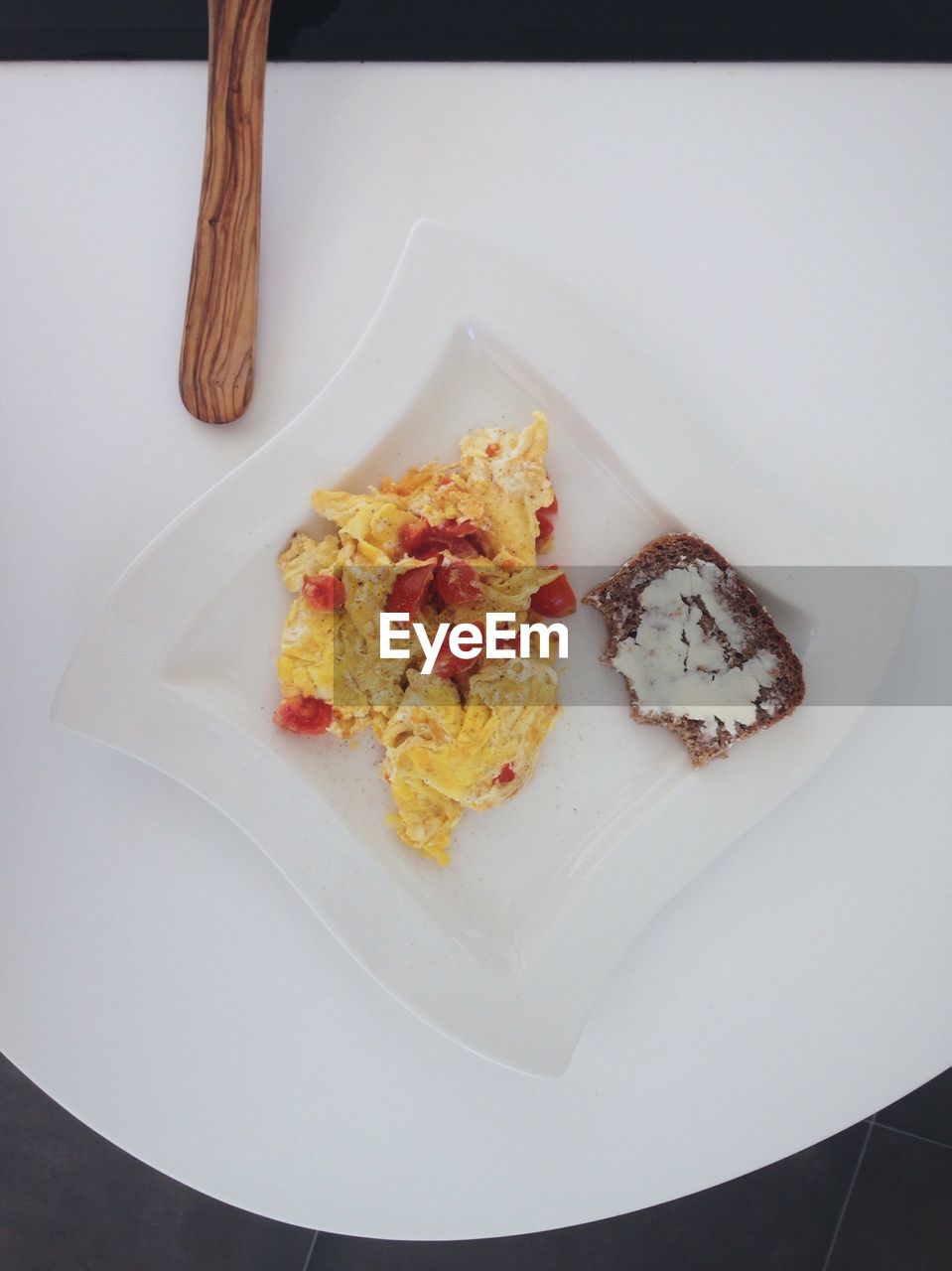 Directly above shot of egg and bread in plate on table