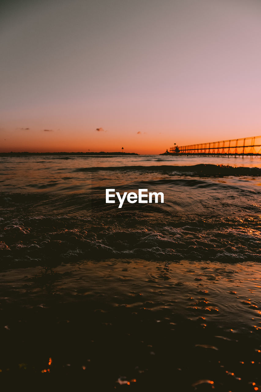 View of a beach with a sunrise in the background