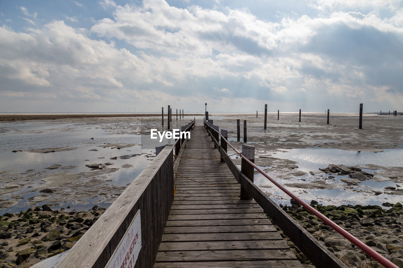 Pier over sea against sky