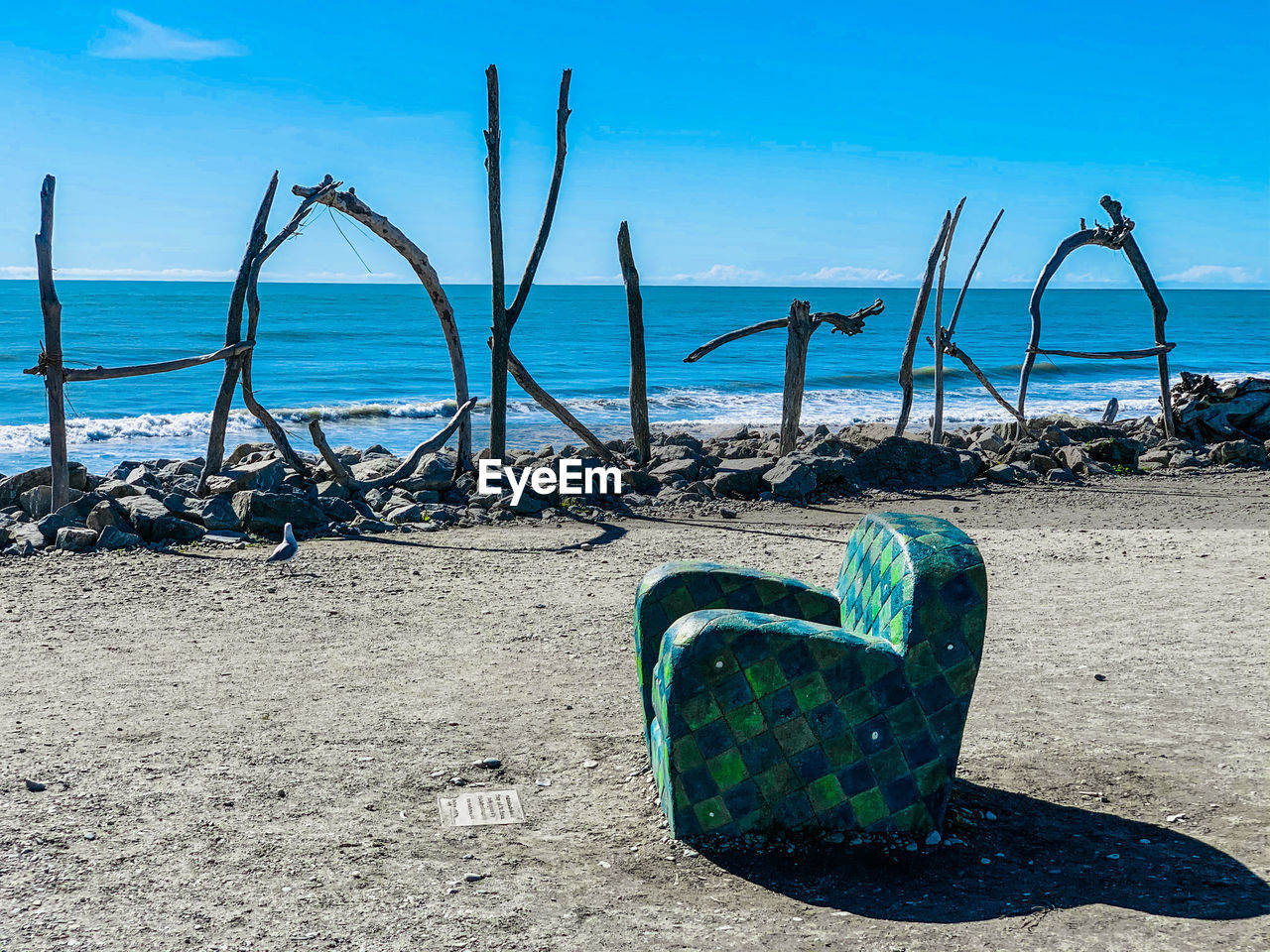 Scenic view of sea shore against blue sky