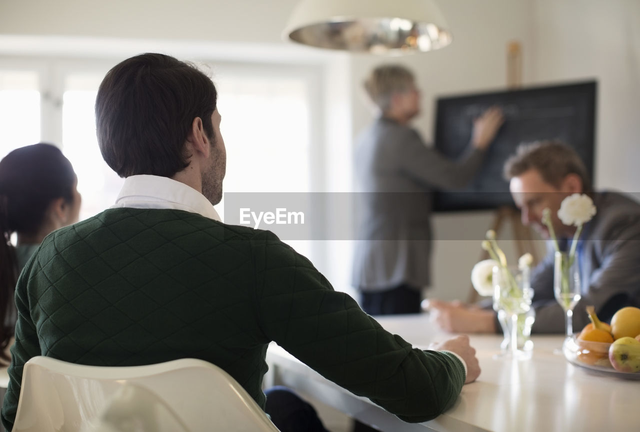Rear view of businessman in meeting