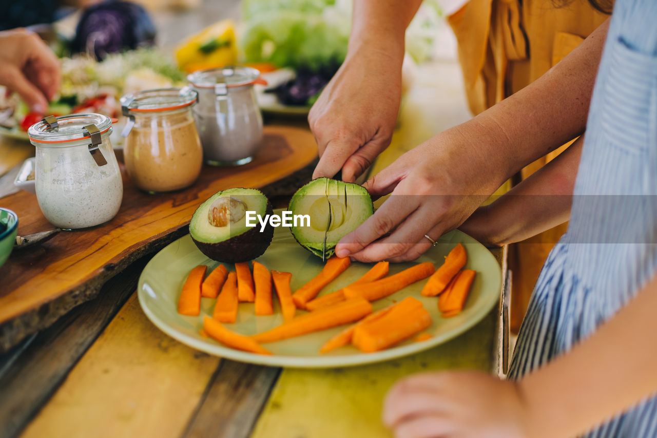 Image of hands cutting an avocado