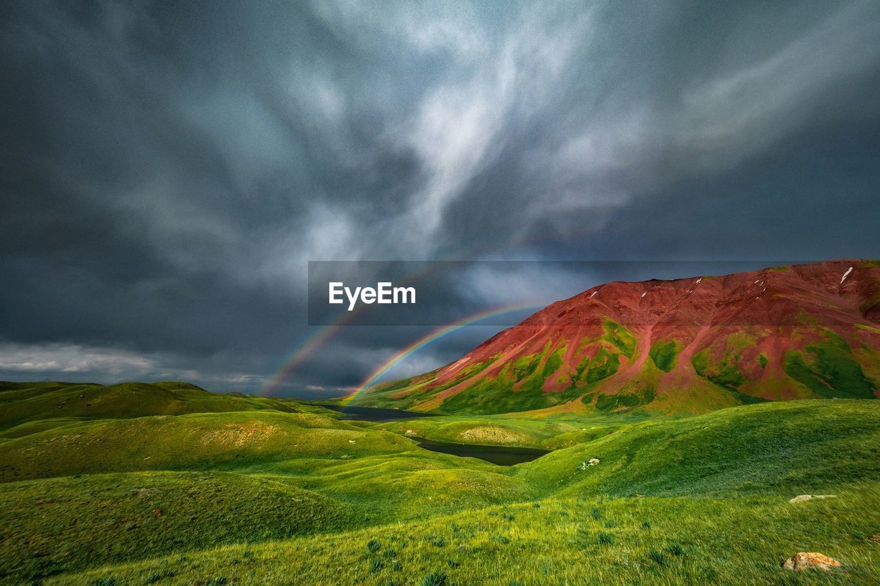 Scenic view of mountain against cloudy sky