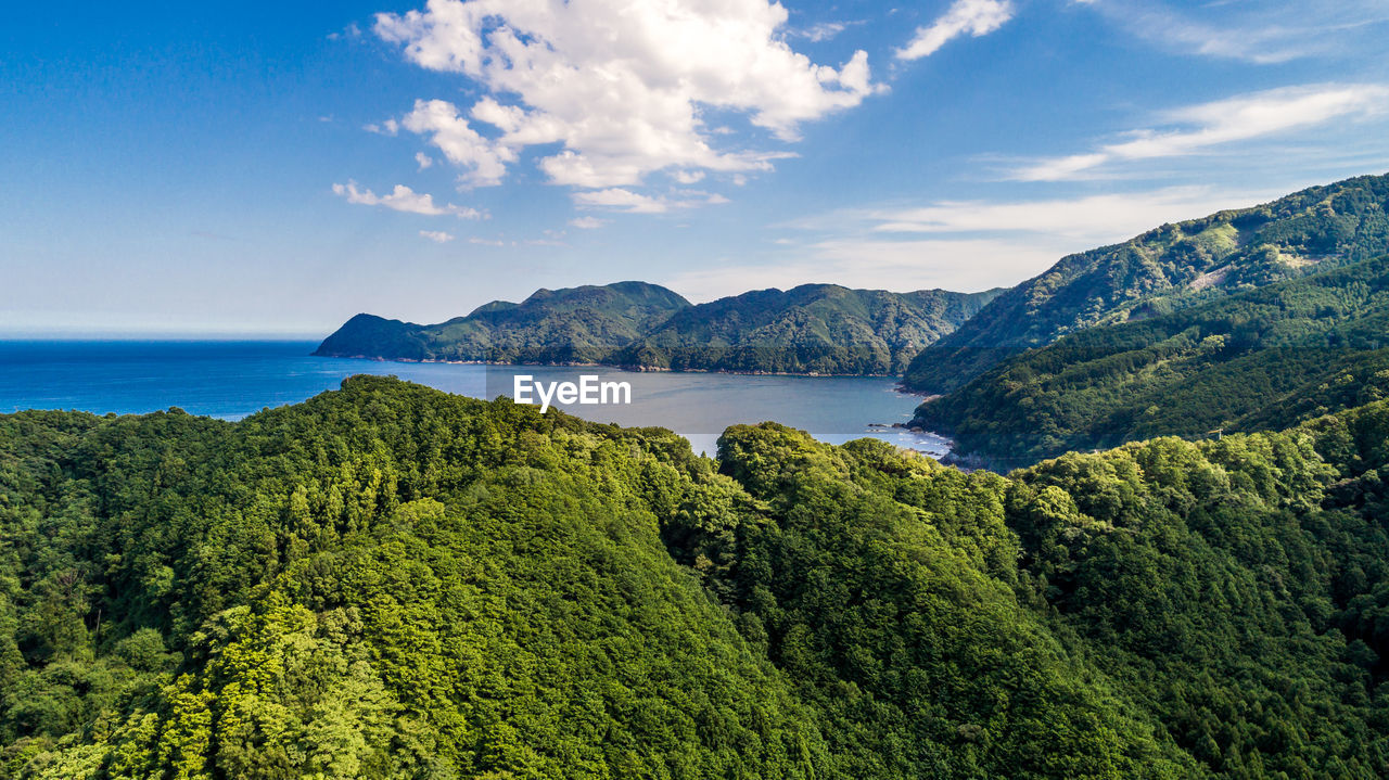 Scenic view of sea and mountains against sky