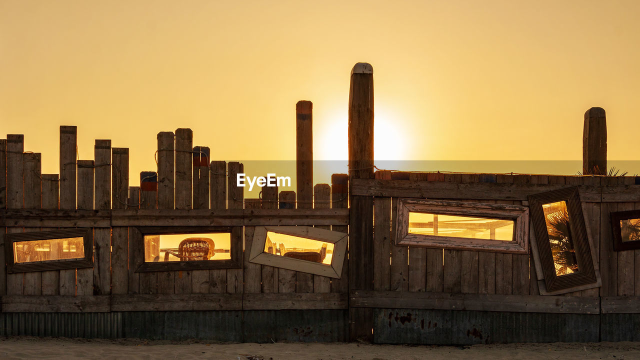 Buildings in city against clear sky during sunset