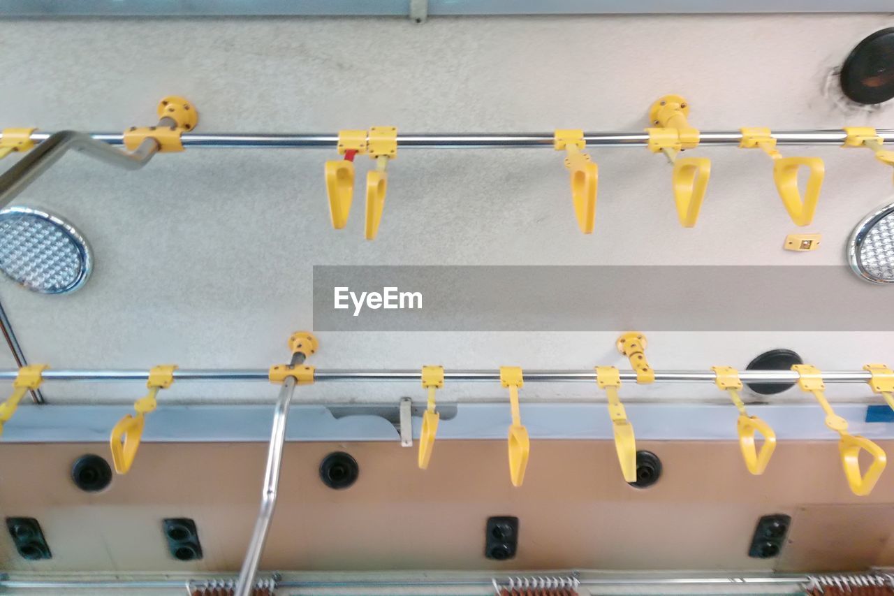 CLOSE-UP OF CLOTHESPINS HANGING ON RAILING