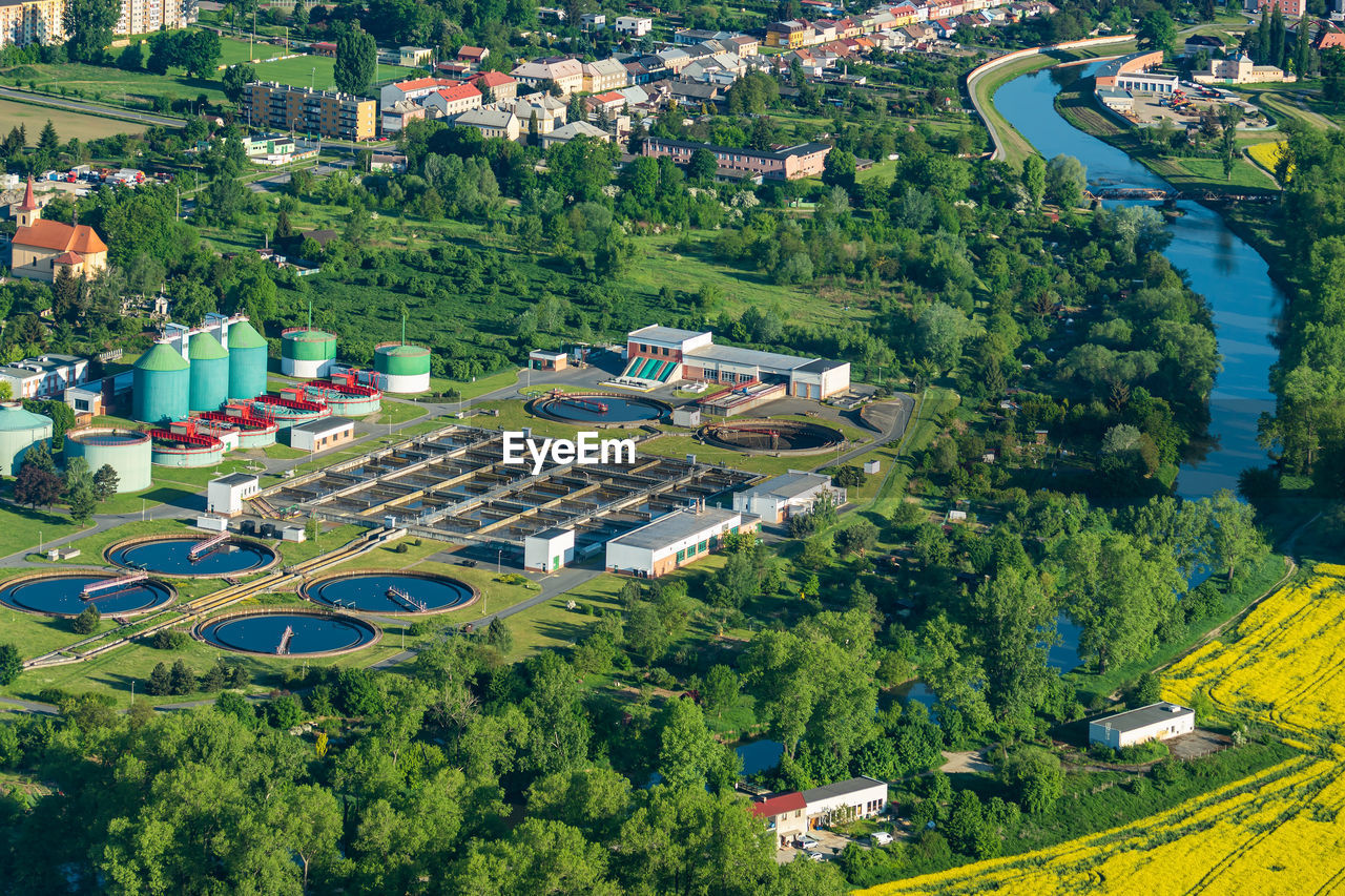 Aerial view of sewage treatment plant near the river and residential area