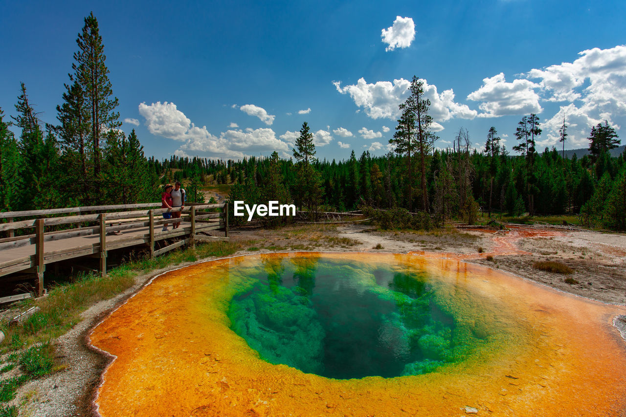 Hot spring at yellowstone national park against blue sky