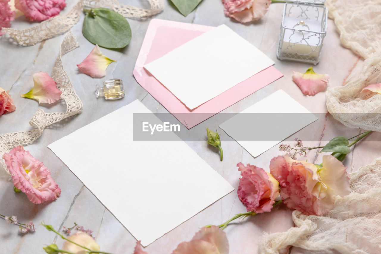 Wedding stationery set with envelope laying on a marble table 