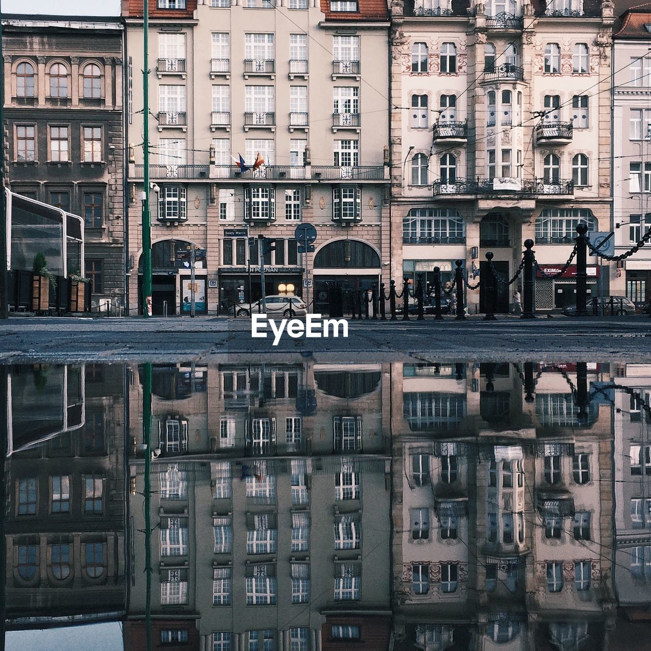 Reflection of buildings in puddle