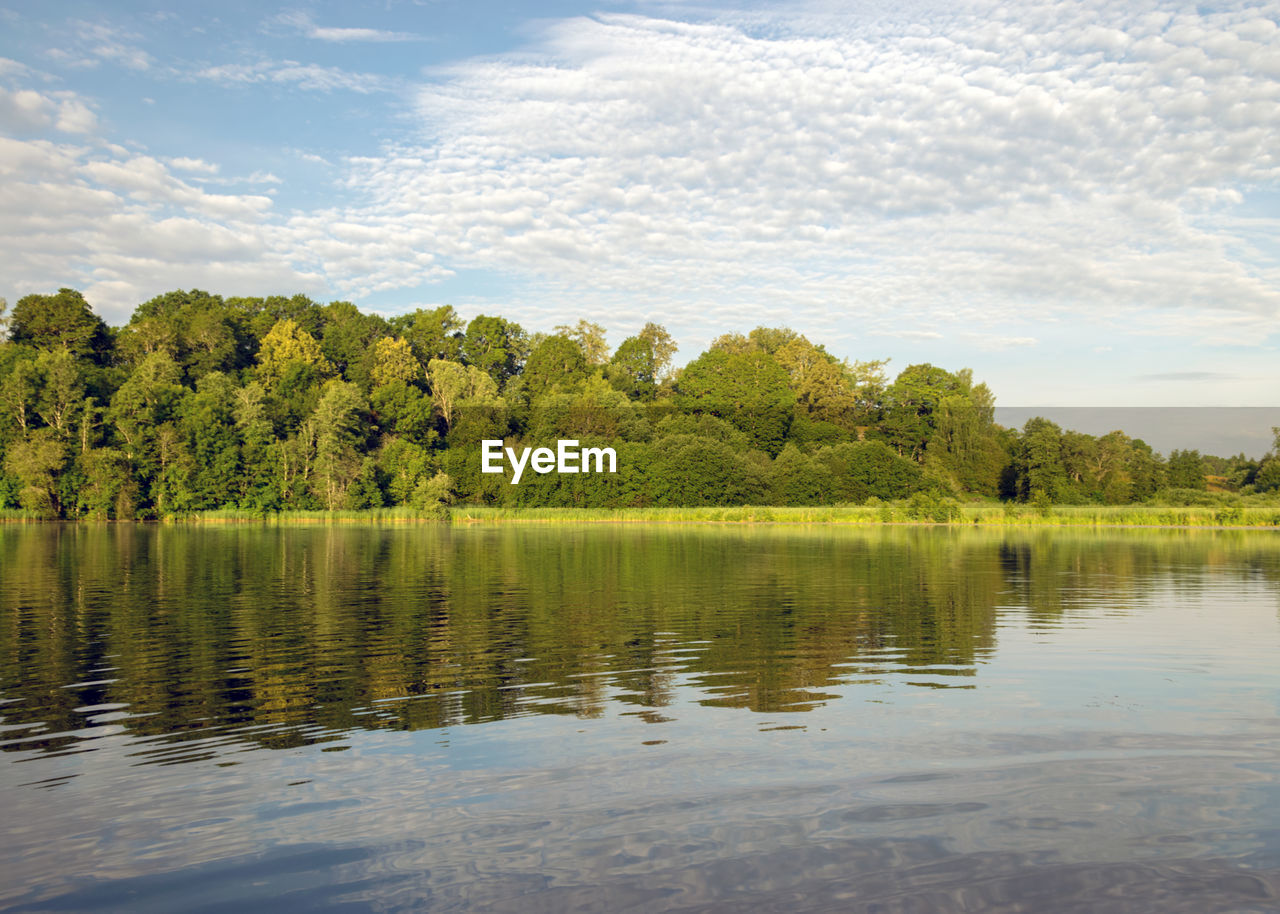 Morning landscape on the lake, beautiful clouds and wonderful reflections in the lake mirror