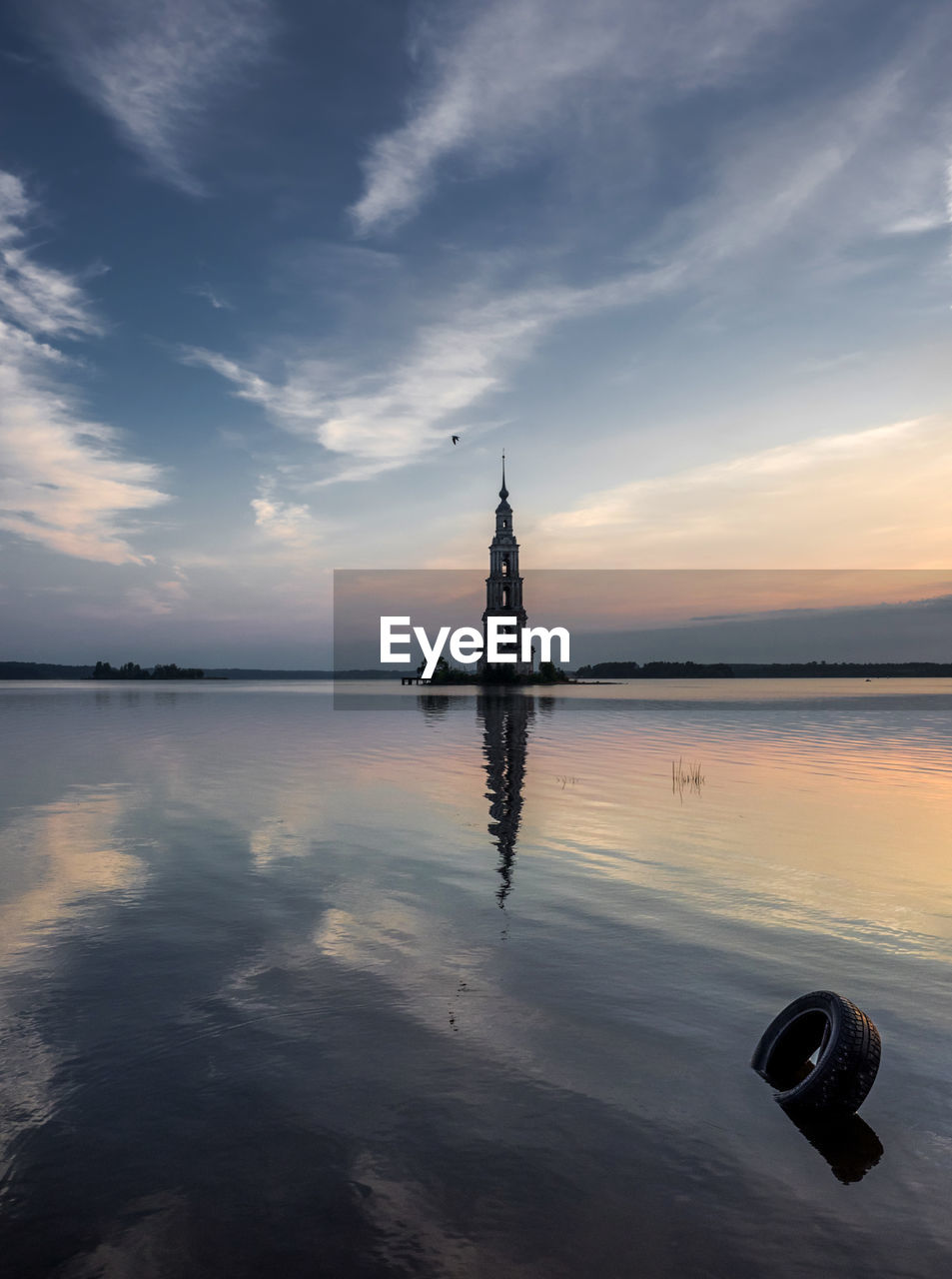 Mid distance view of kalyazin bell tower in volga river during sunset