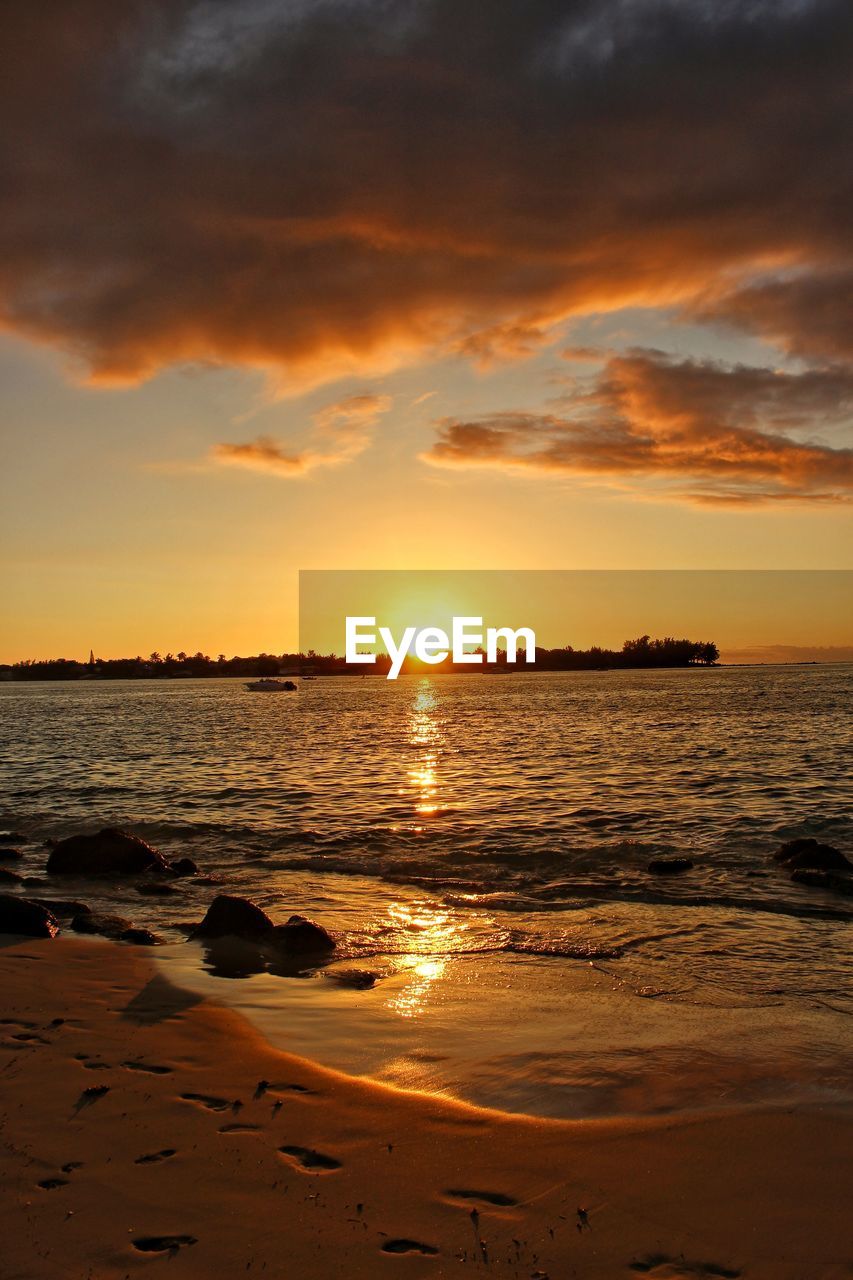 Scenic view of sea against dramatic sky