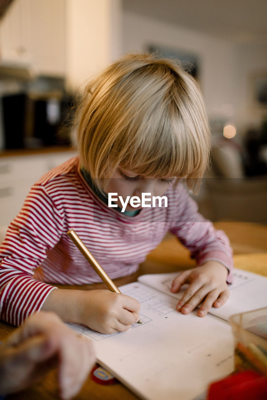 Boy doing homework at table