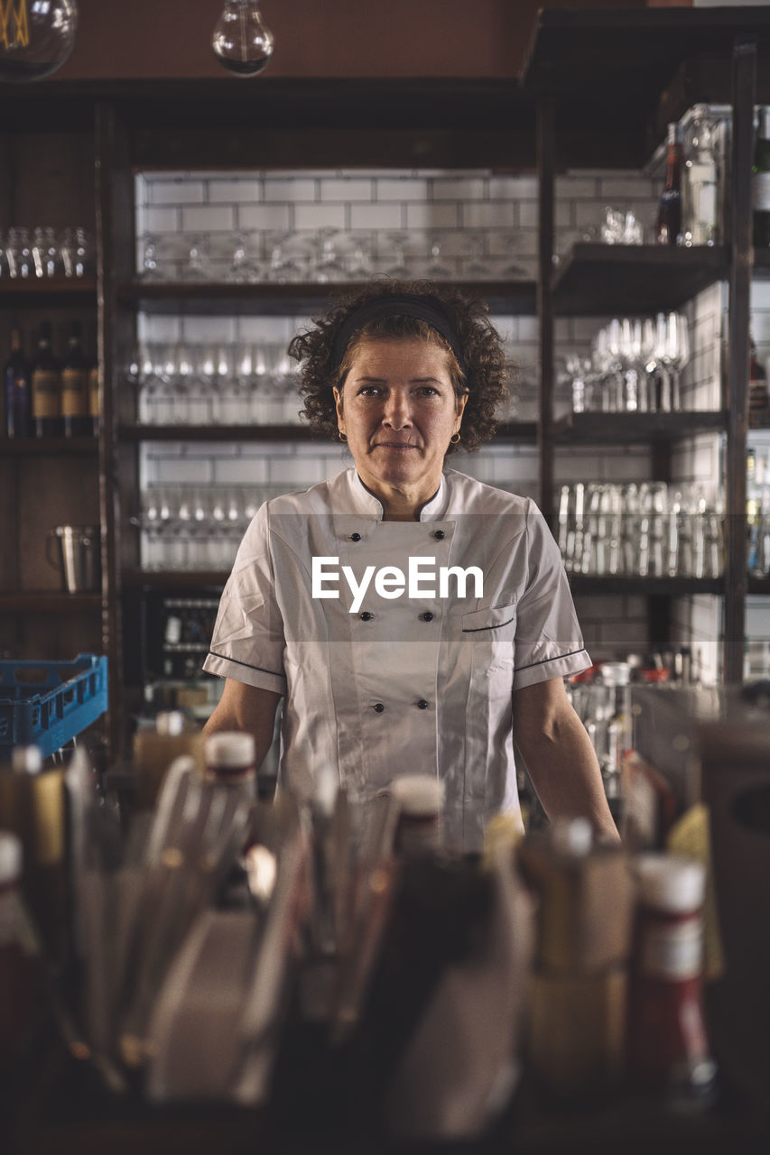 Portrait of female chef in commercial kitchen
