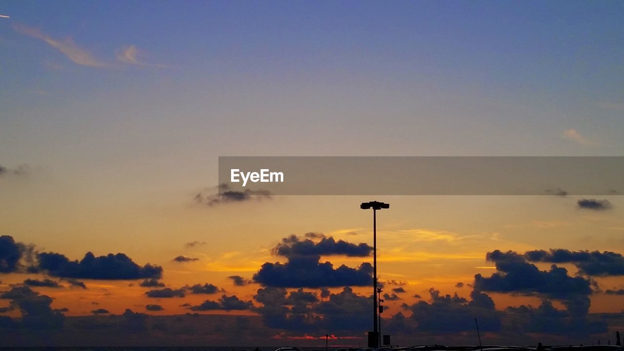 SILHOUETTE OF STREET LIGHT AGAINST SKY