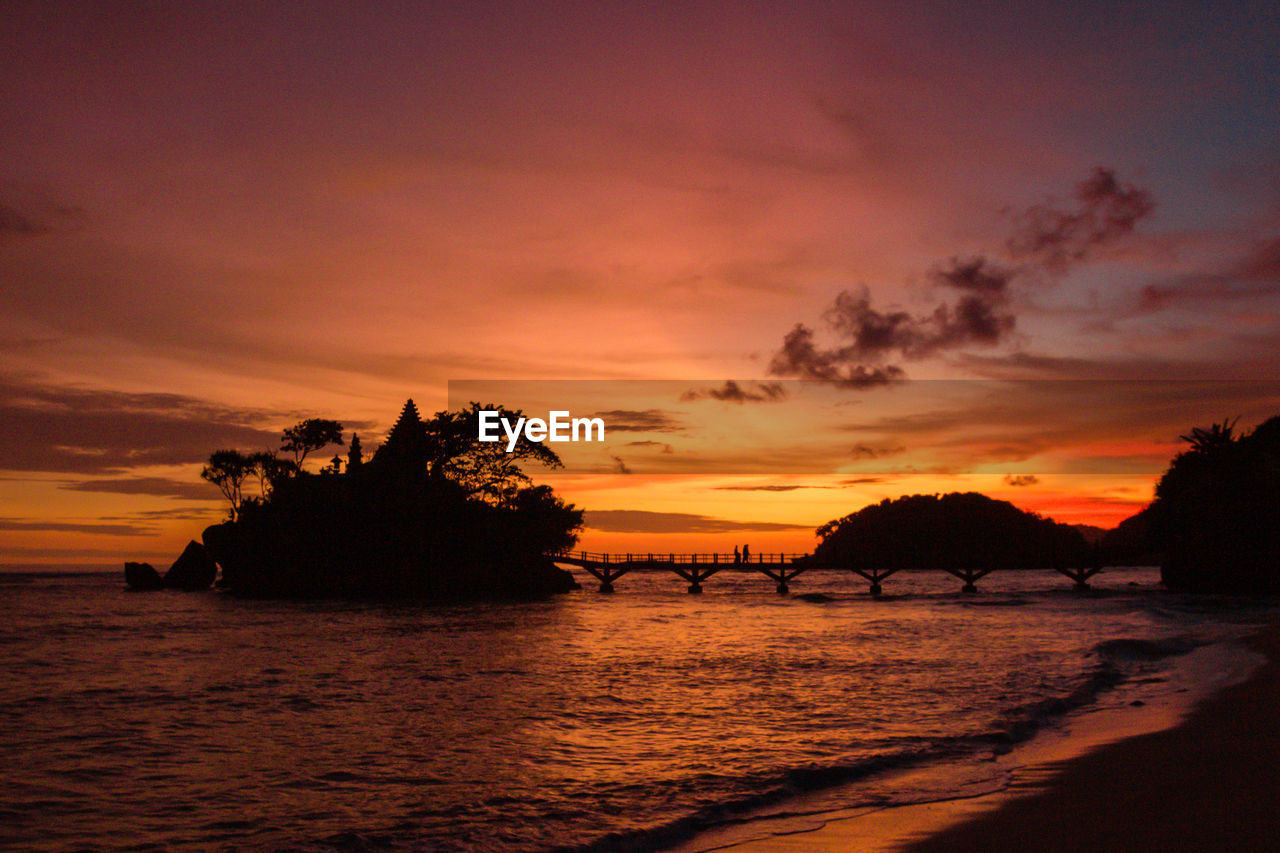 Scenic view of sea against romantic sky at sunset