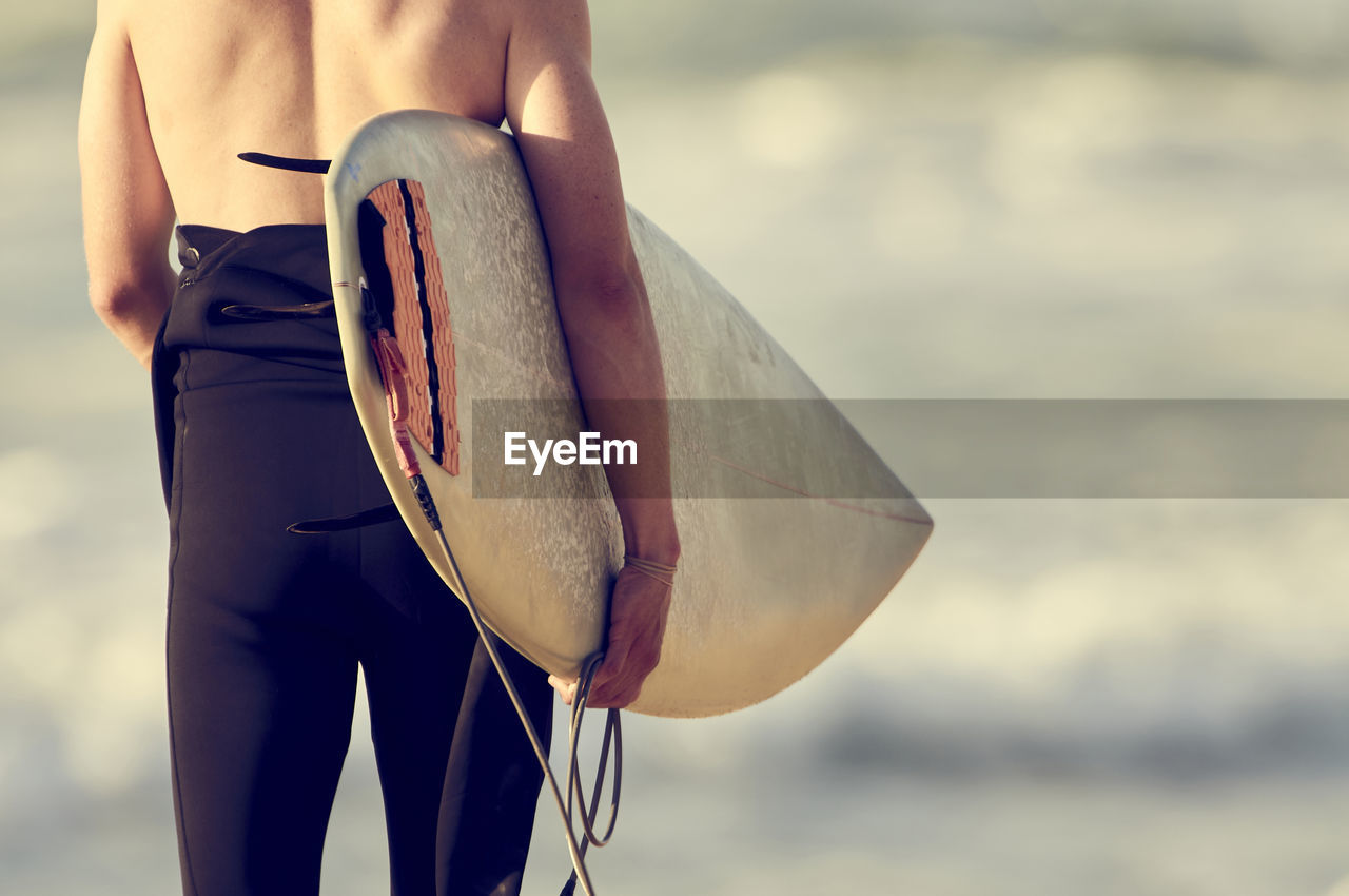 Man with board ready to surf