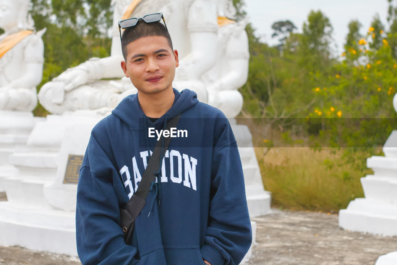 Portrait of a handsome young man standing outdoors