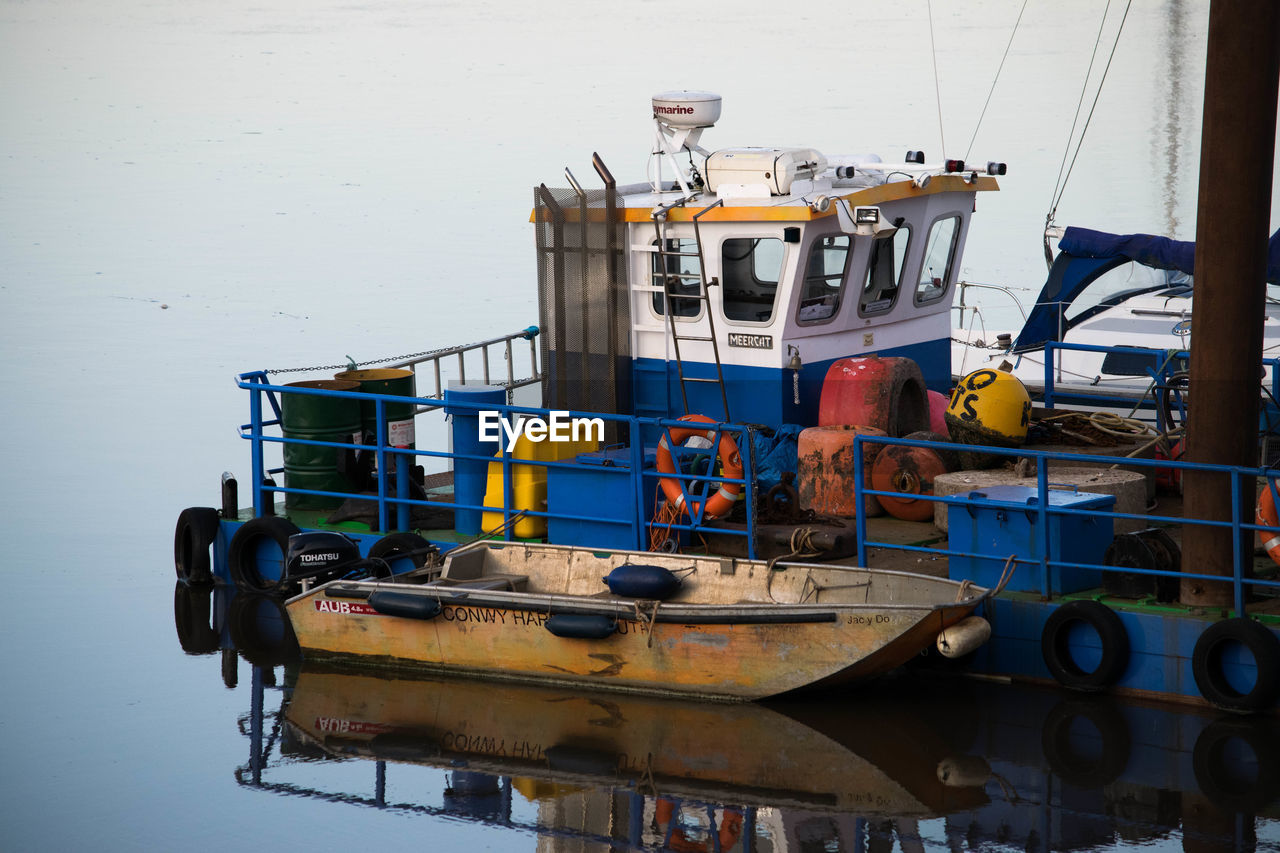 FISHING BOATS MOORED AT HARBOR