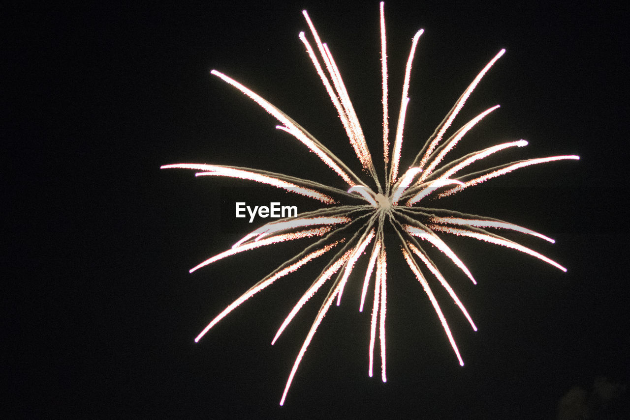 LOW ANGLE VIEW OF FIREWORKS IN SKY