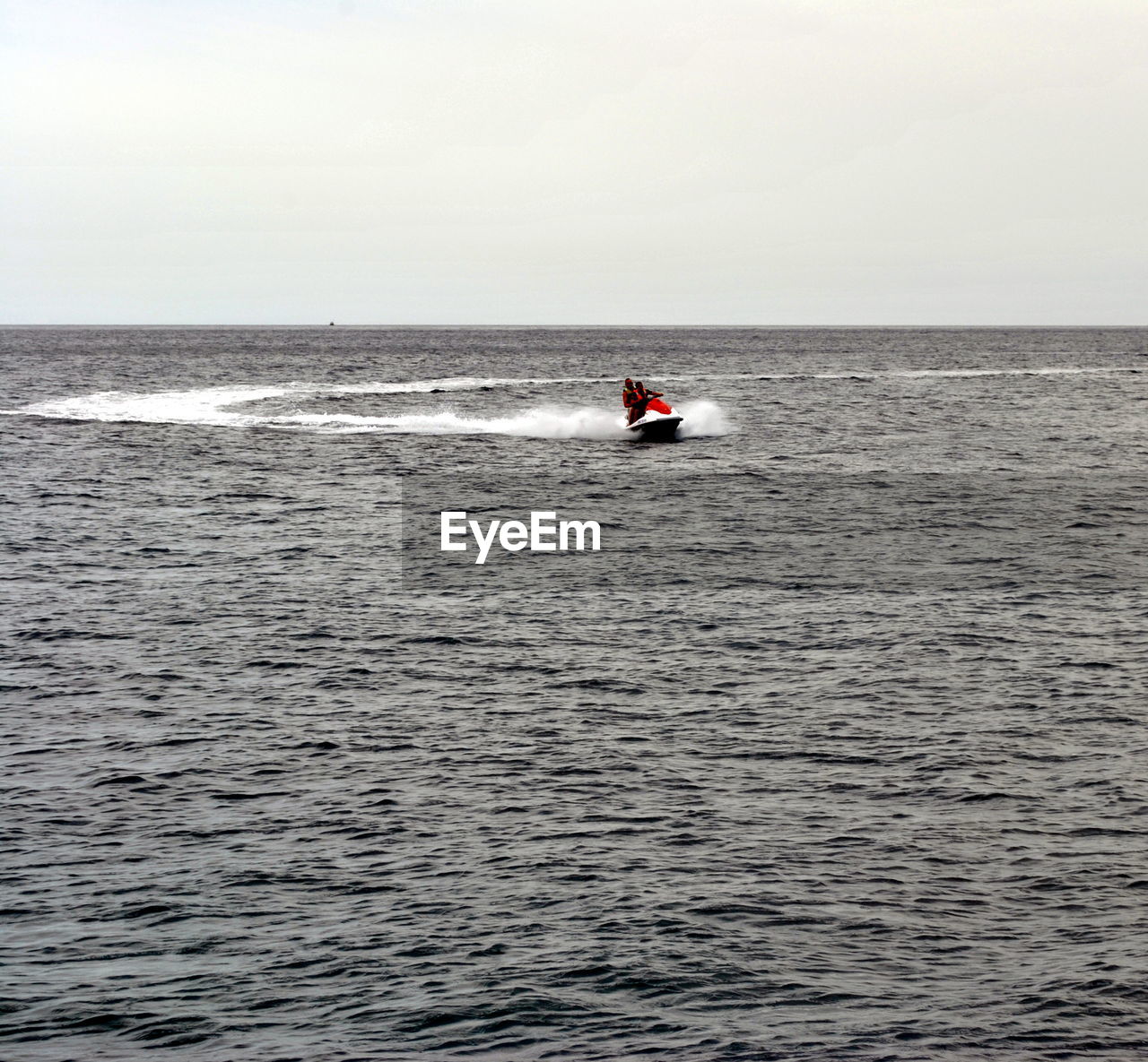 MAN IN SEA AGAINST SKY