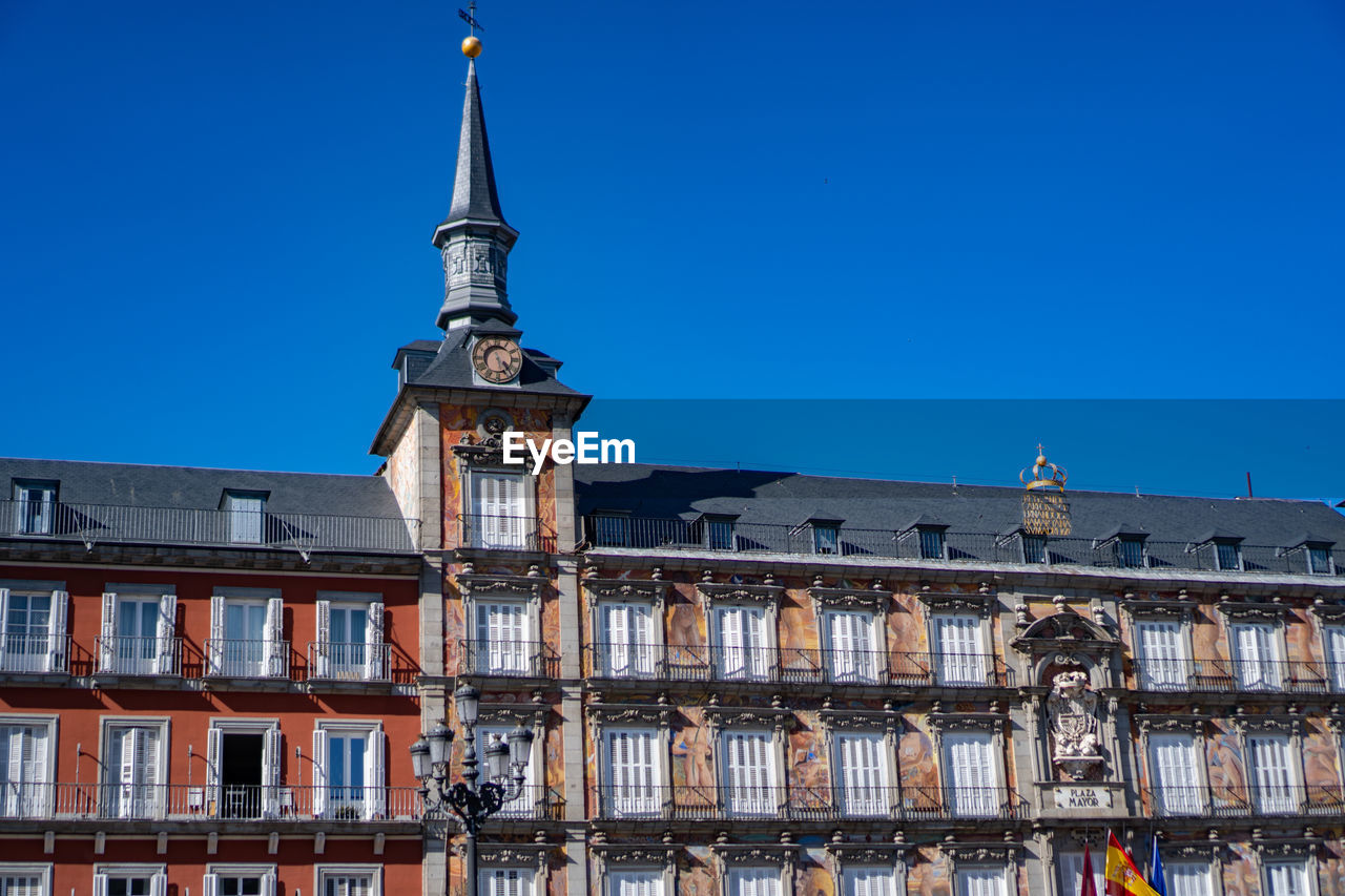 Low angle view of building against clear blue sky