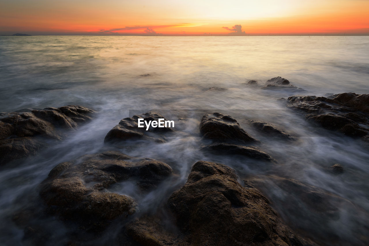 Scenic view of sea against cloudy sky