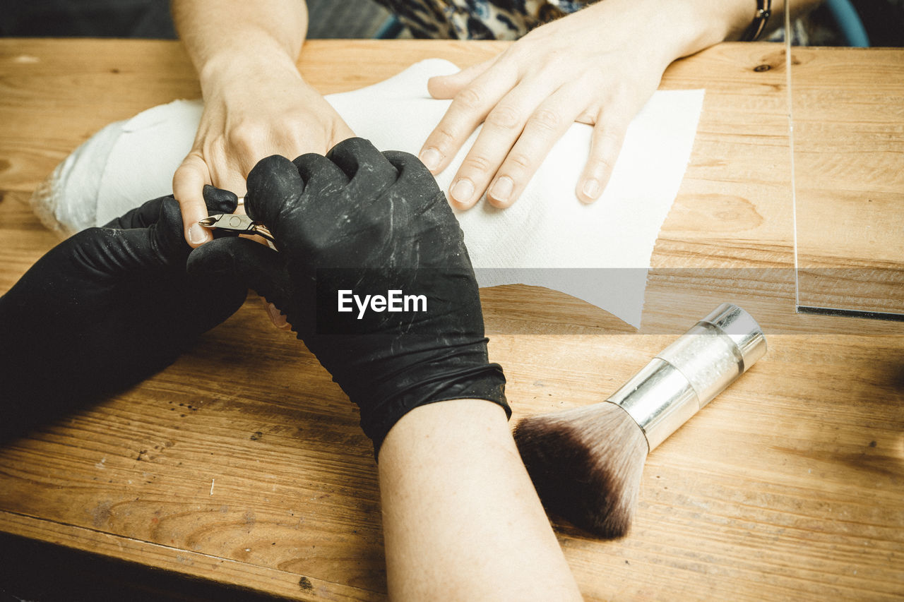 Beautician working with mask and protective screen for the virus covid