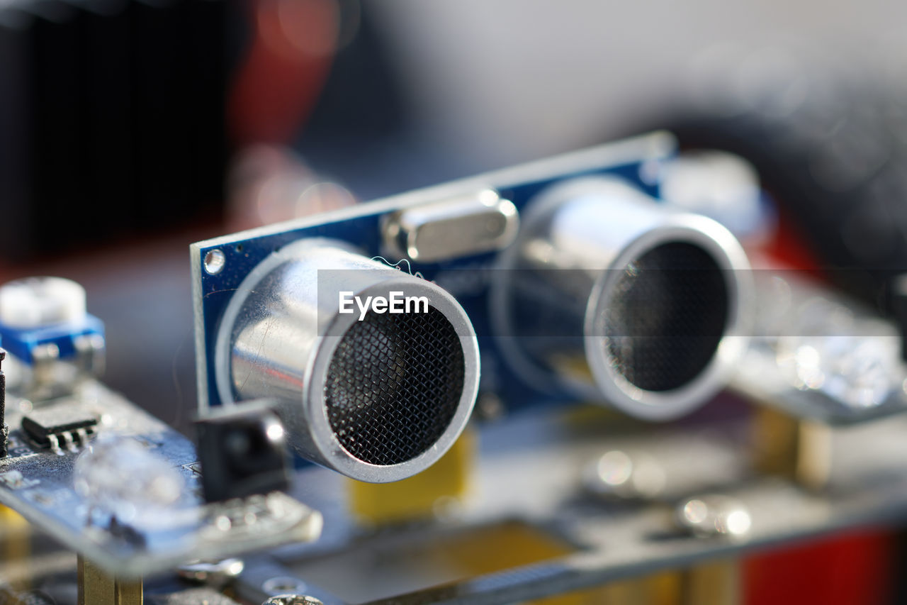 technology, music, close-up, arts culture and entertainment, vehicle, sound recording equipment, selective focus, noise, indoors, microphone, equipment, focus on foreground, no people, input device, metal