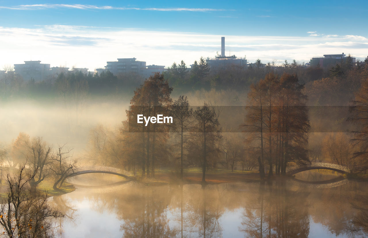 Scenic view of lake against sky during sunrise.
