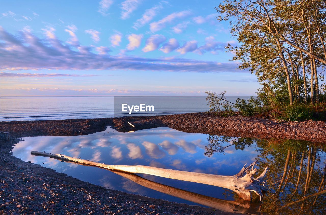 Scenic reflection of clouds in calm sea