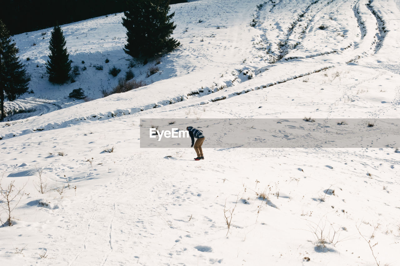 Man standing on snow covered land