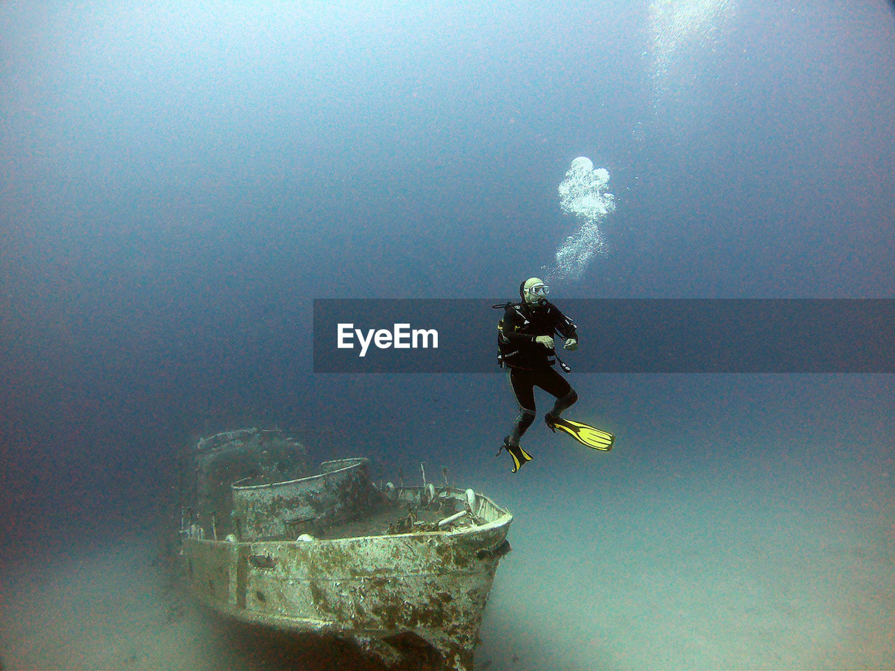 A diver dives next to the wreck.antalya kaş turkey