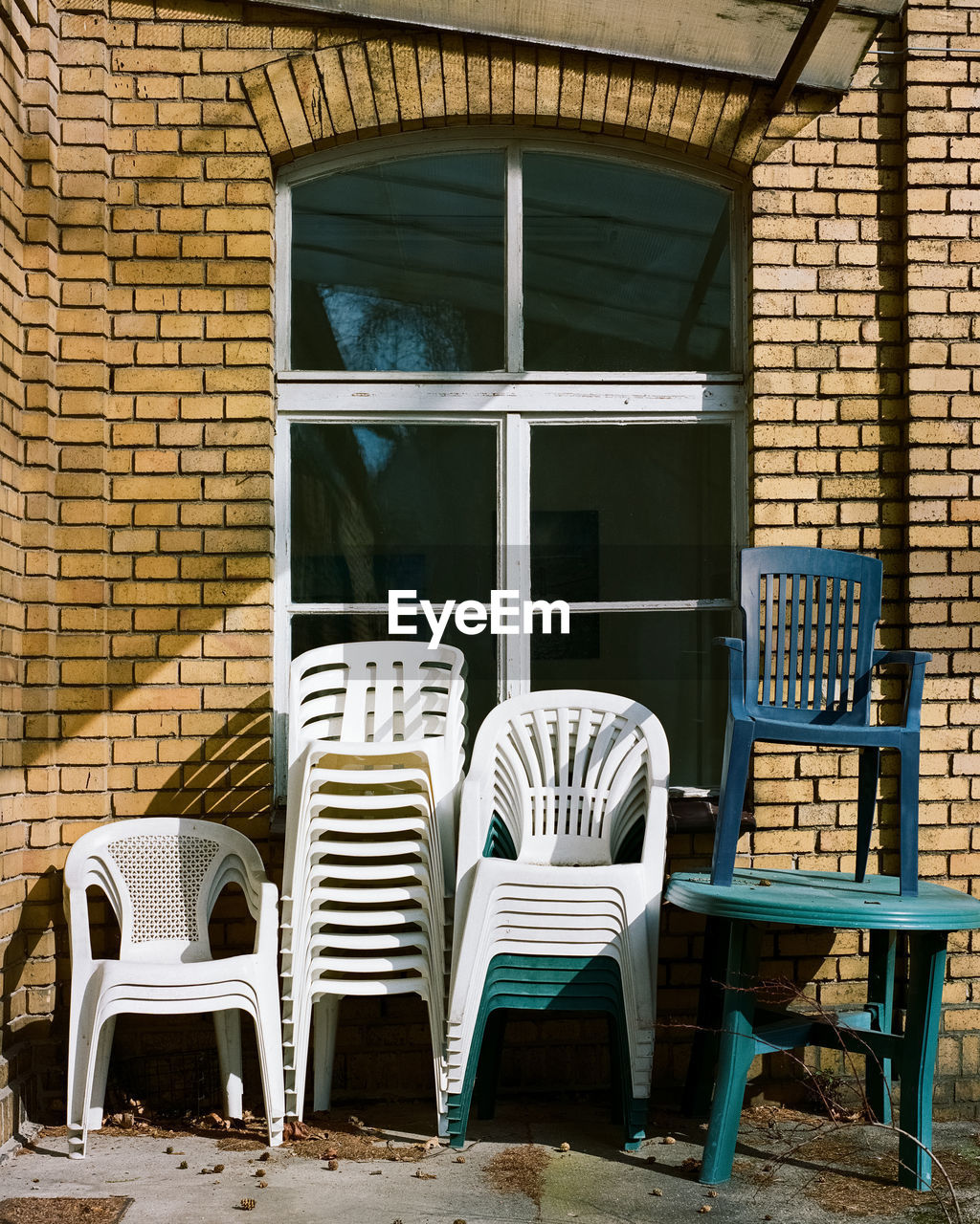 EMPTY CHAIRS AND TABLES AGAINST WINDOW