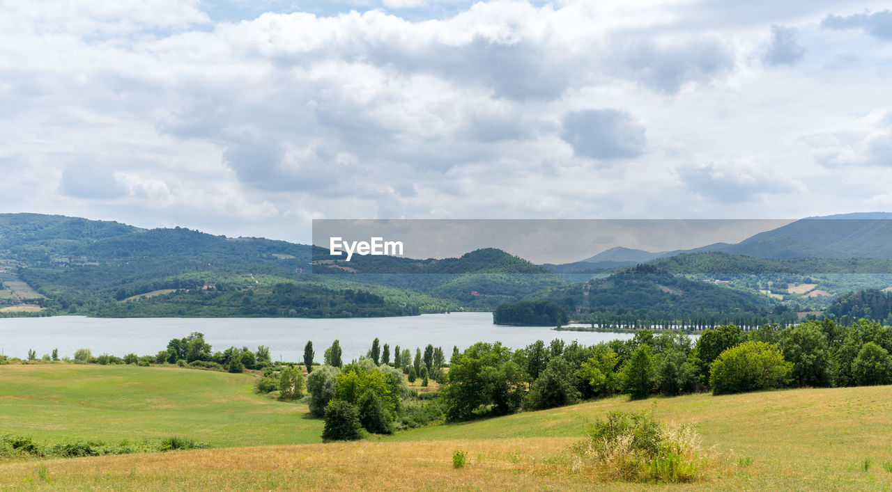 Scenic view of lake and mountains against sky