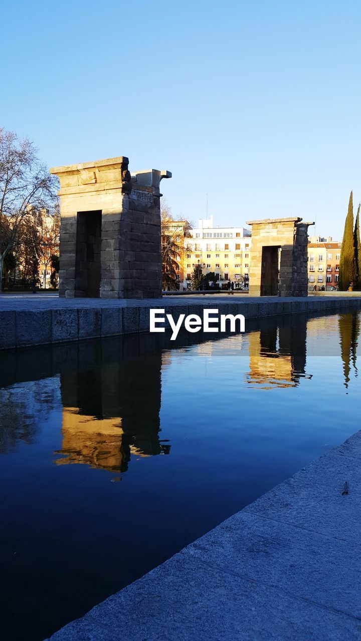 REFLECTION OF BUILDINGS IN RIVER