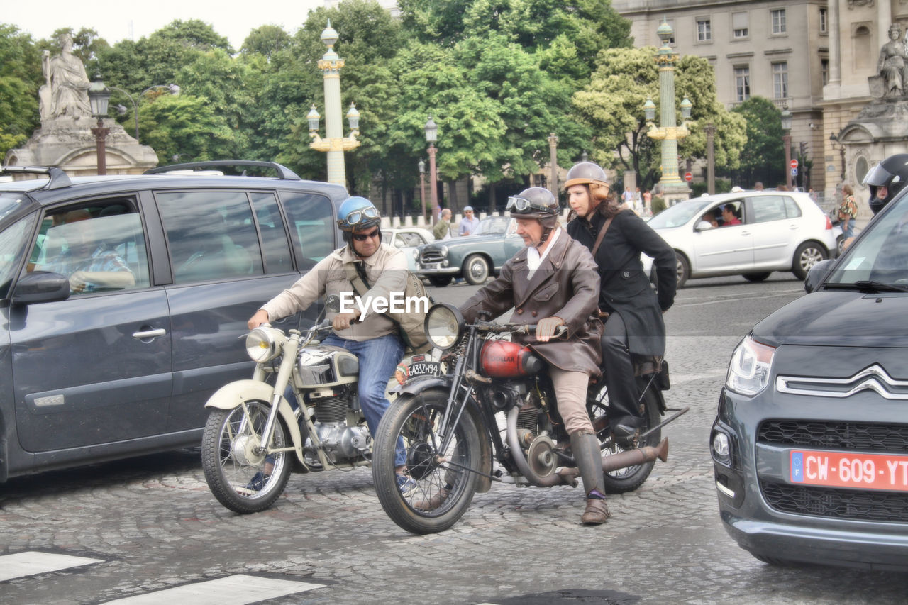 PEOPLE RIDING BICYCLE ON ROAD