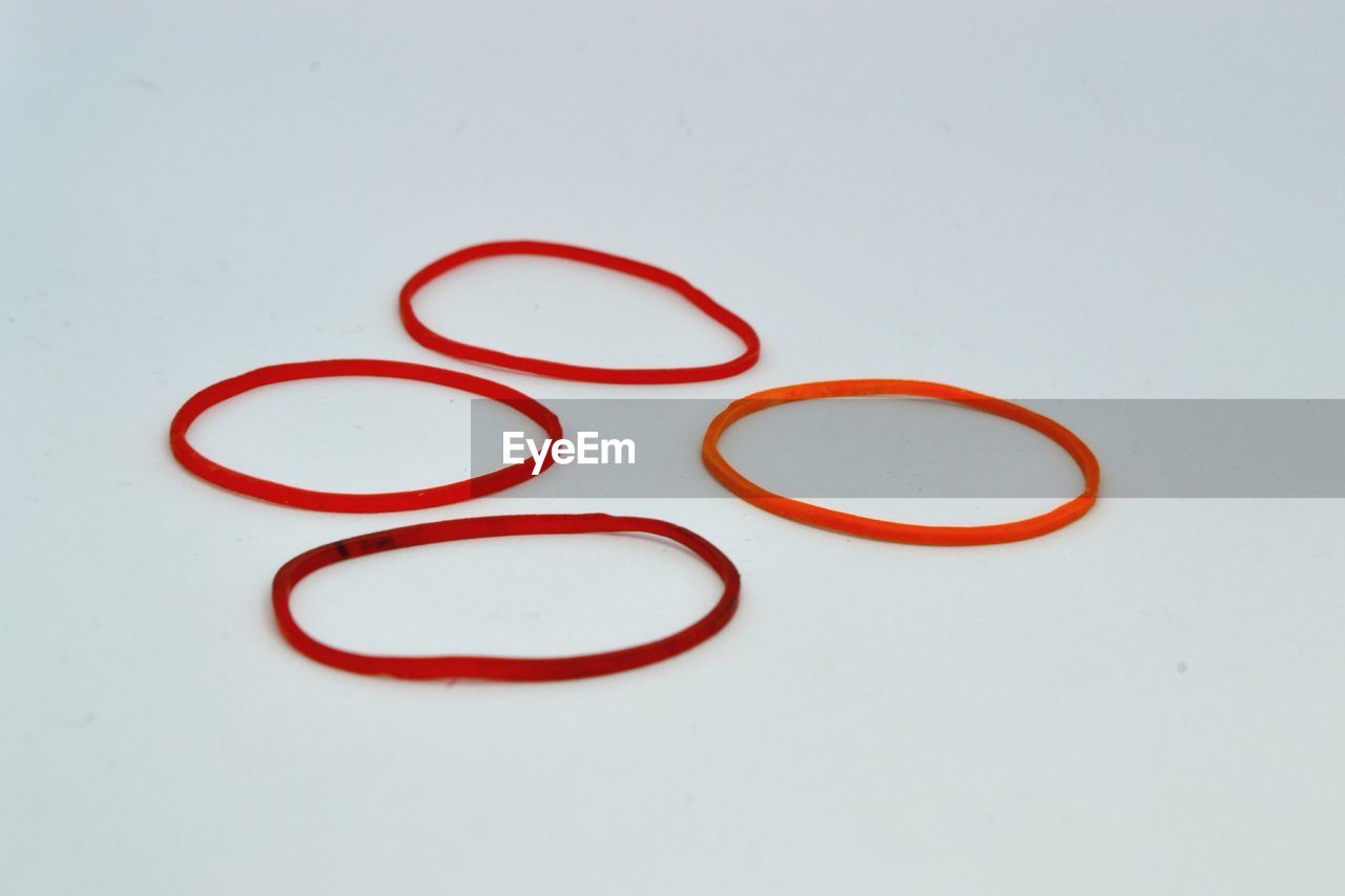 Close-up of rubber bands over white background