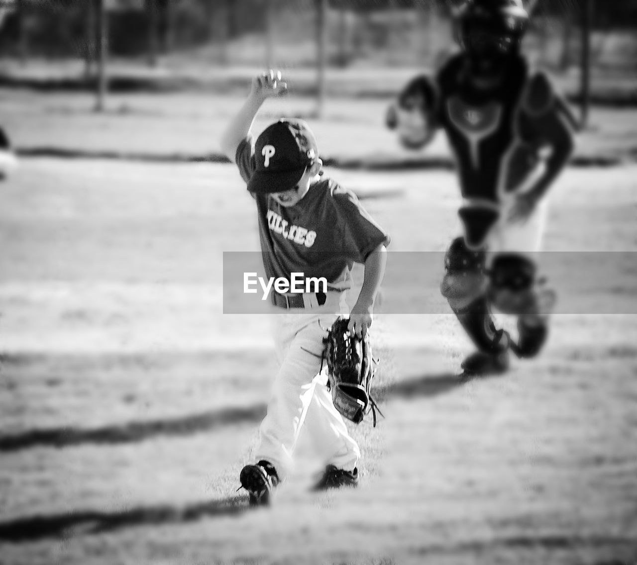 Boy holding baseball glove on playing field