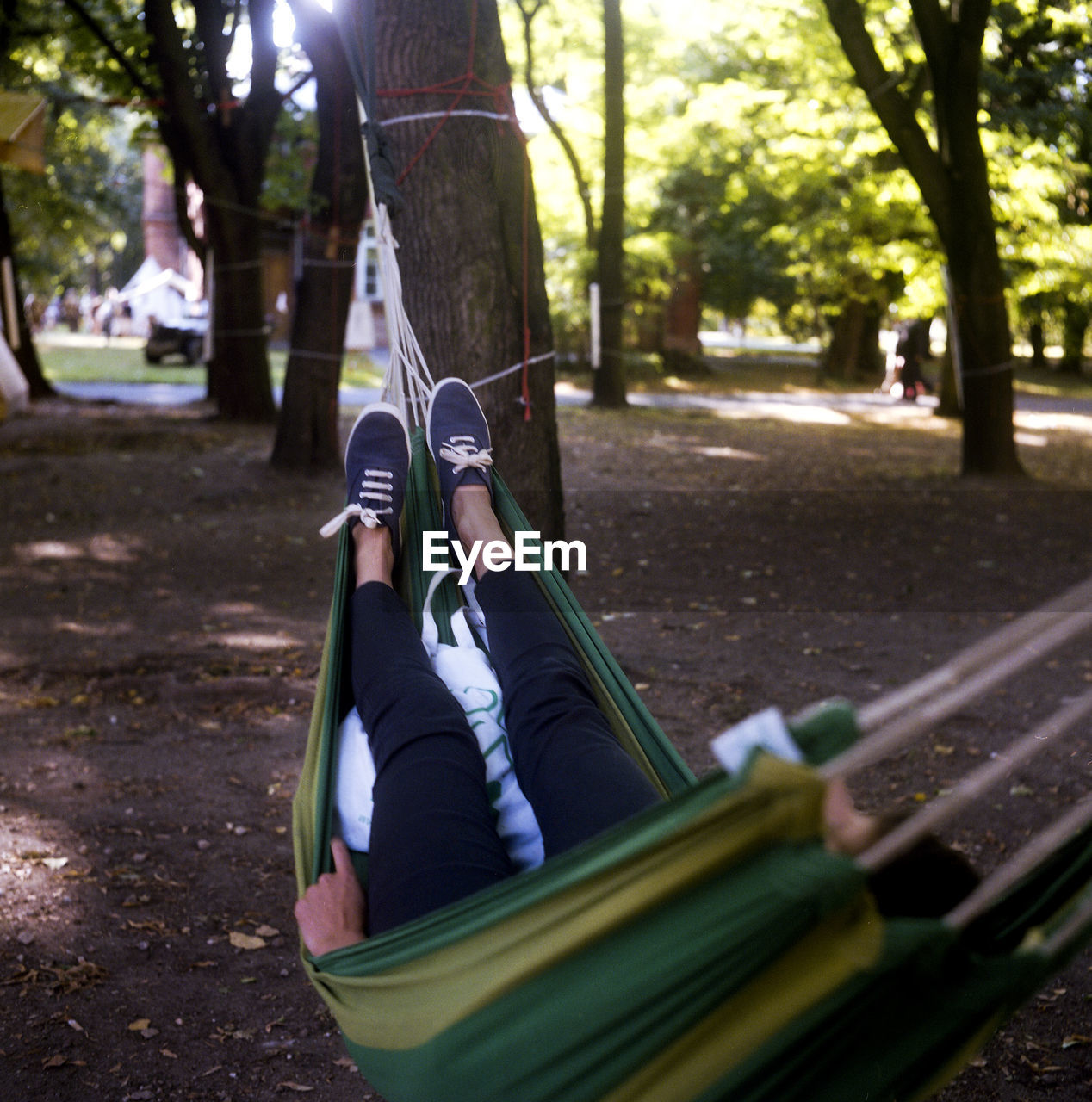 Person relaxing on hammock in park