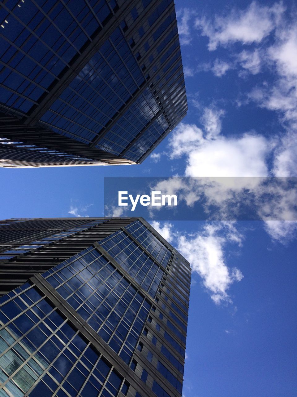 LOW ANGLE VIEW OF BLUE SKY WITH REFLECTION OF CLOUDS IN FOREGROUND