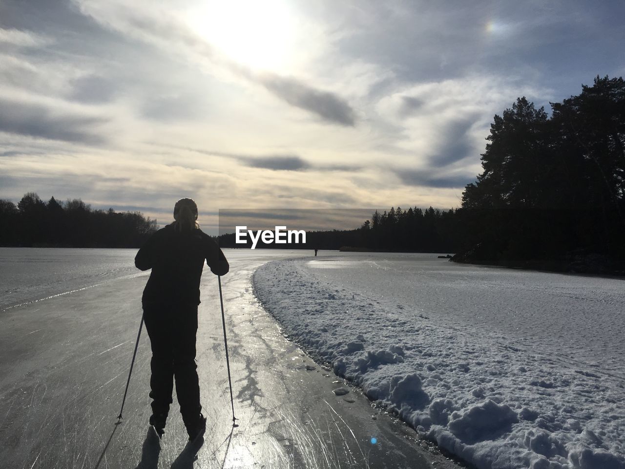 REAR VIEW OF A MAN ON SNOW